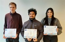 Three proud students holding their certificate of completion of their Semiconductor Packaging minor