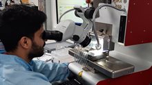 Semiconductor packaging student studying samples through microscope