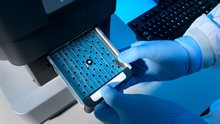 Hands putting a sample in Scanning Electronic Microscope